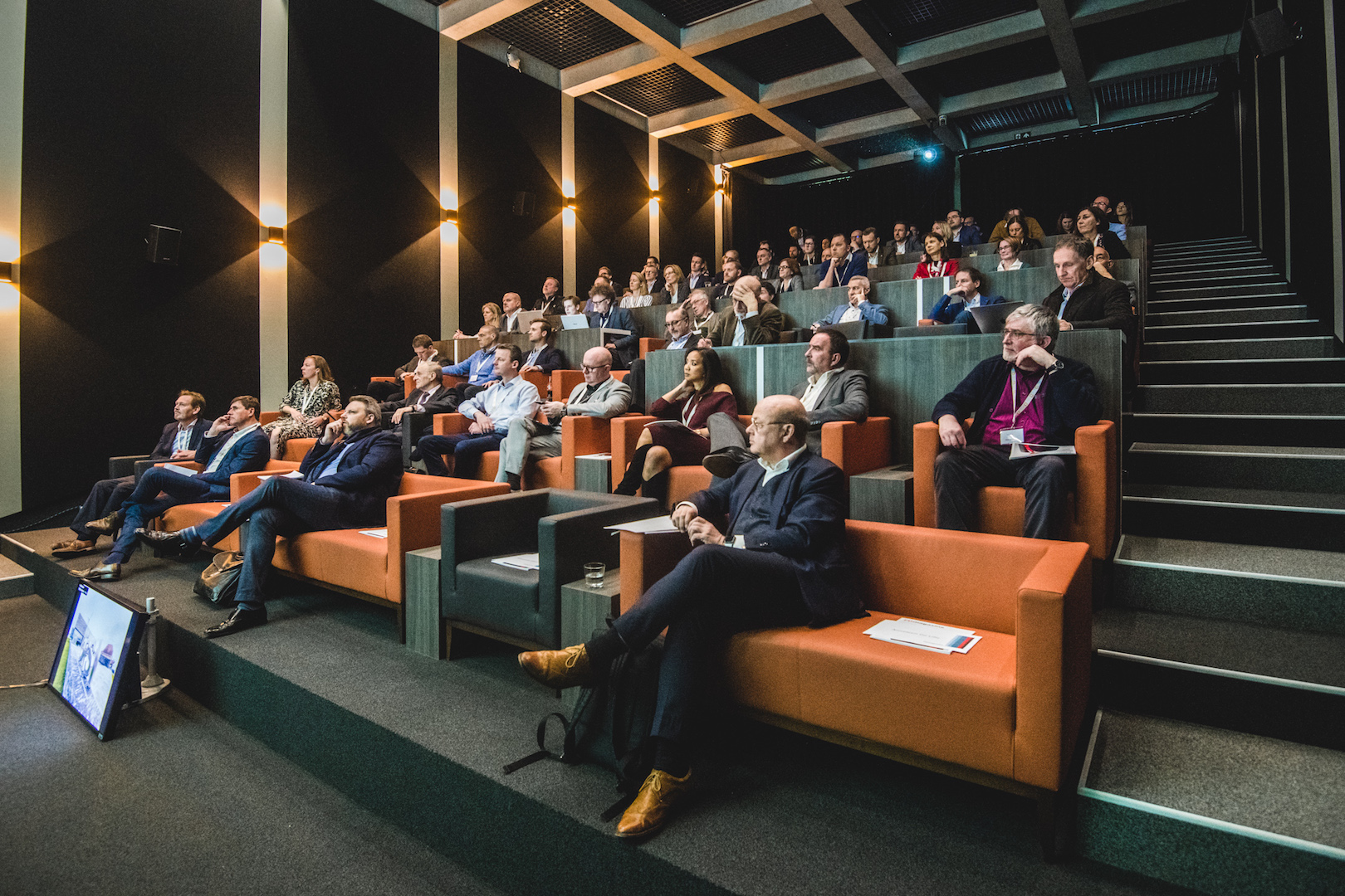 wide angle shot of people sitting in a auditorium