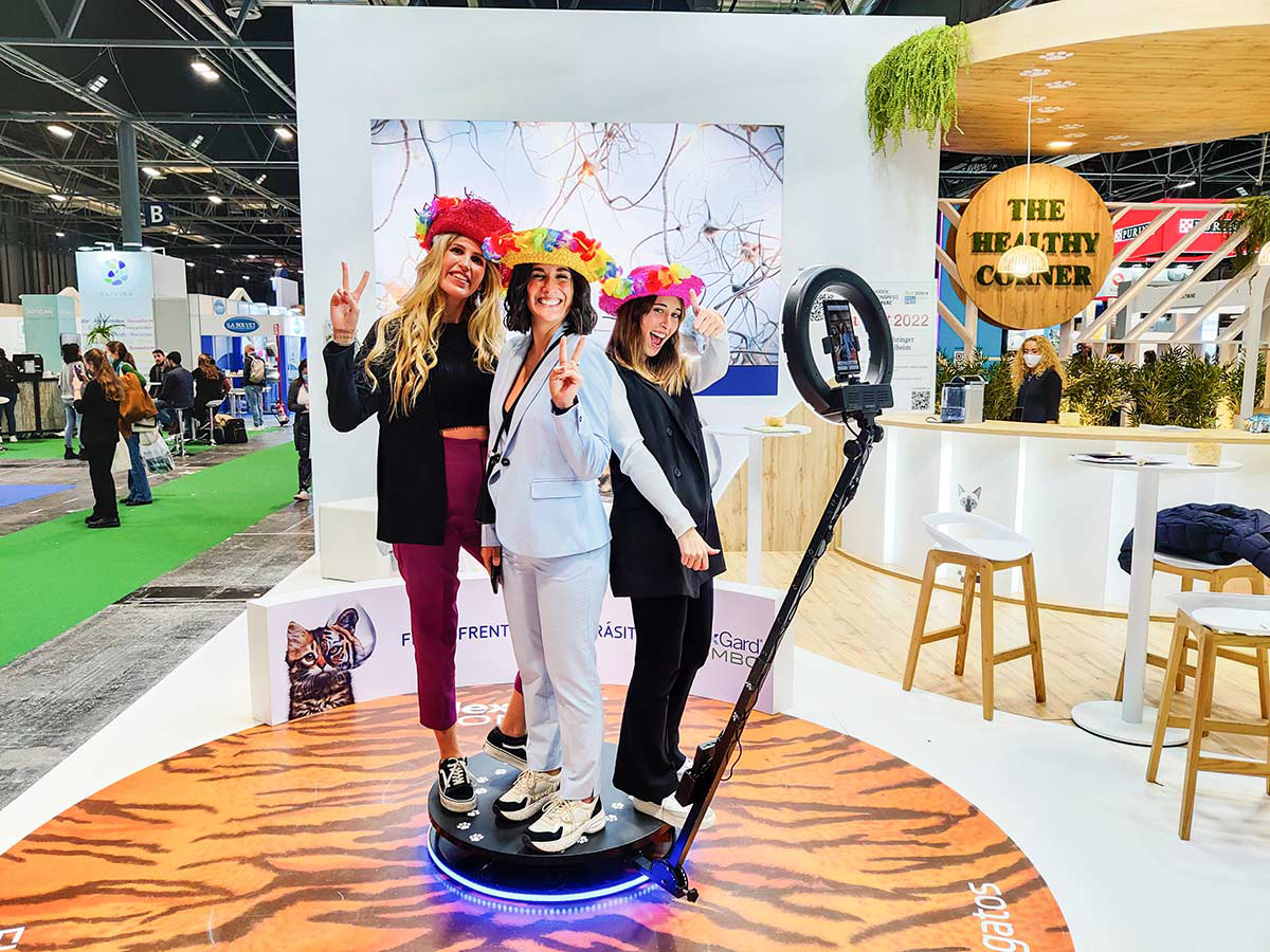 picture of three woman standing on a 360 photobooth at an event